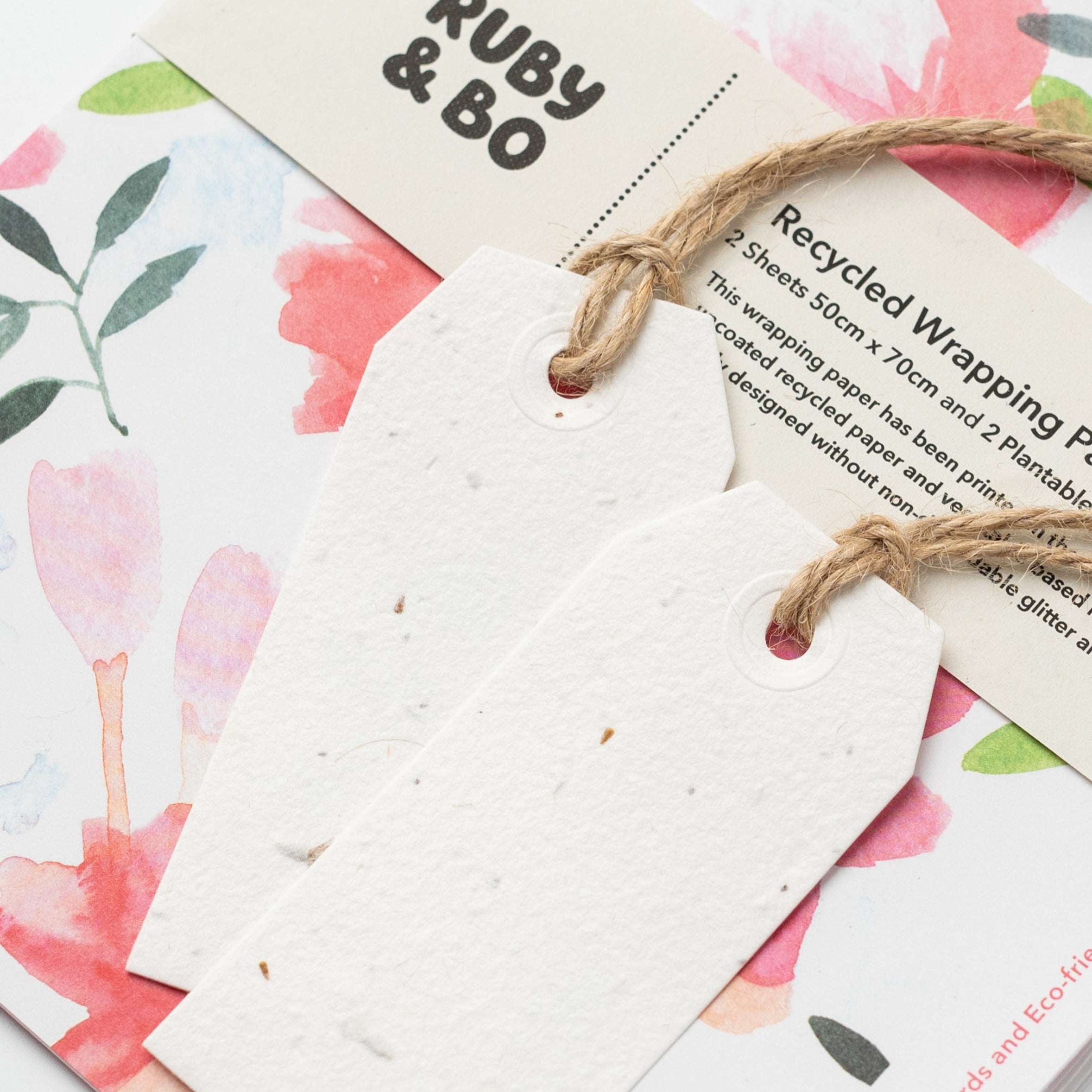 A close up of Ruby & Bo Roses Recycled Wrap & Plantable Tag Set