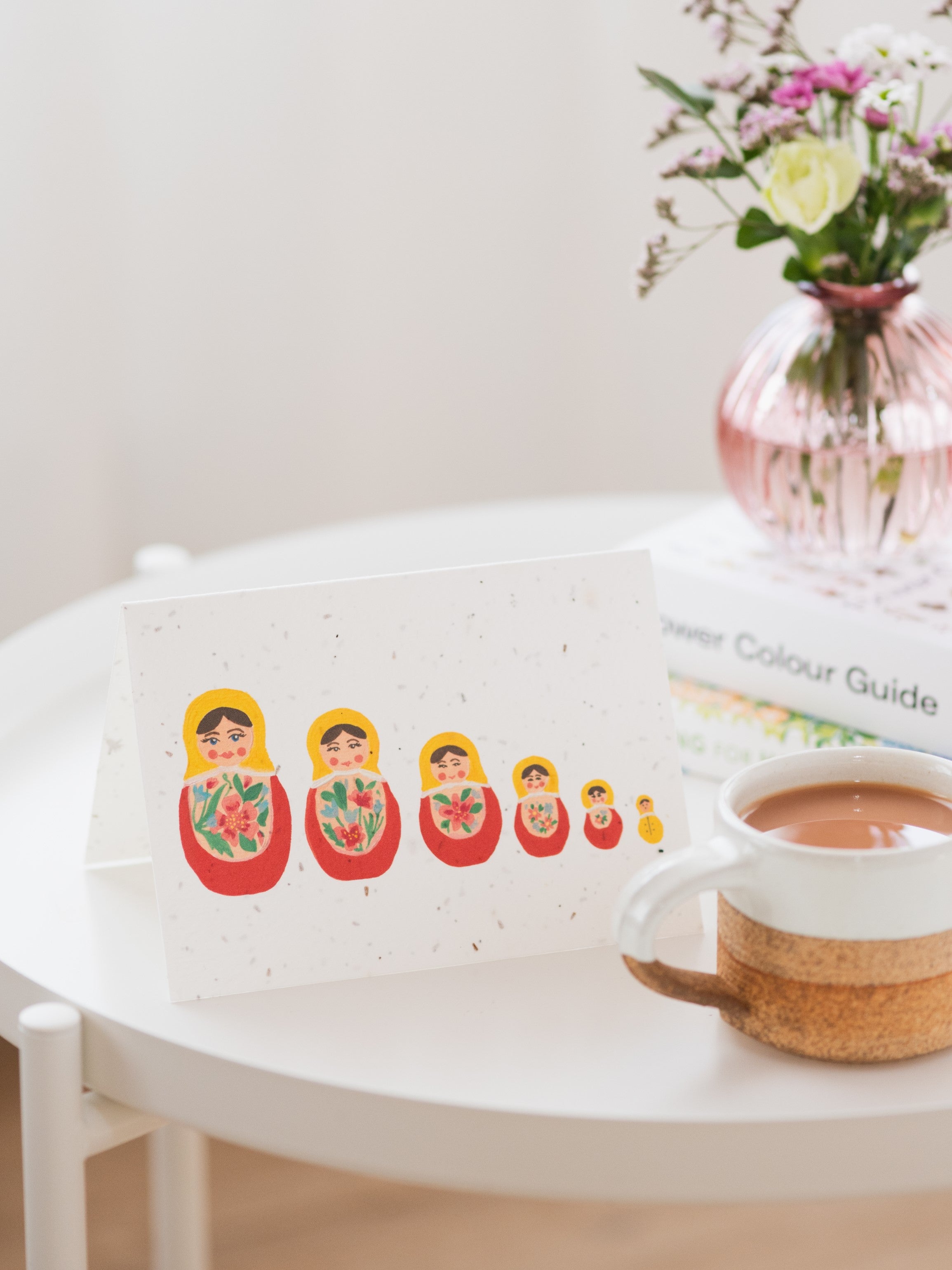 A plantable new baby card on coffee table beside mug of tea
