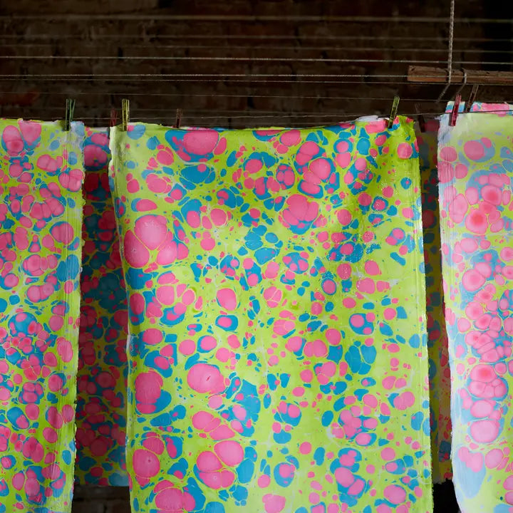 Hand marbling wrapping paper hanging to air dry