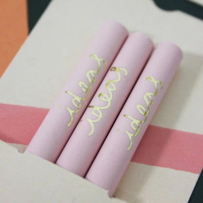 Close up of light pink recycled pencils showing golf foil inscription on exterior