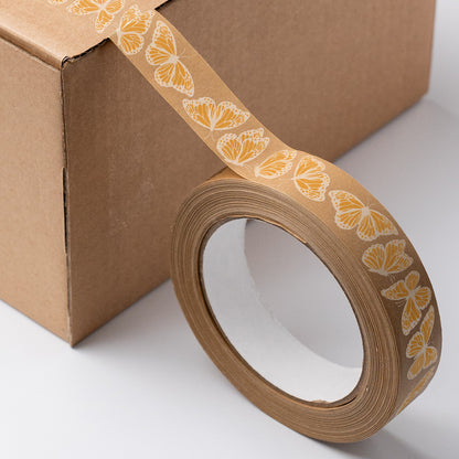 Roll of eco-friendly paper tape featuring delicate butterfly illustrations, with softly printed orange design and natural paper texture